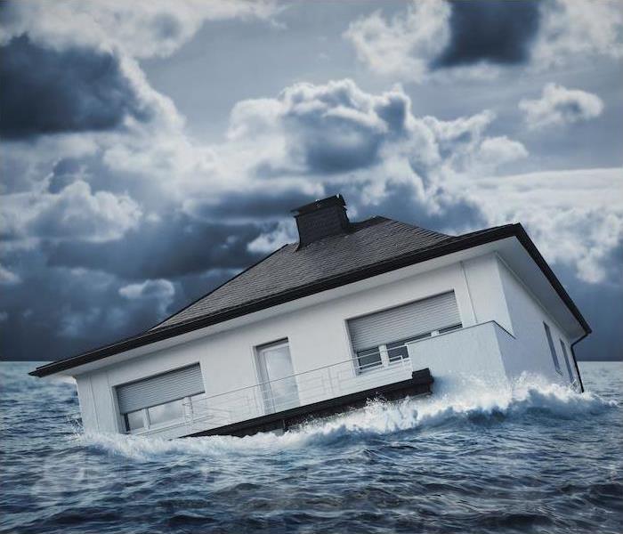 ”house.jpg” alt = “a house floating in a large body of water