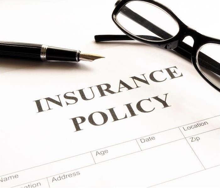 Insurance policies with a pen and glasses near me