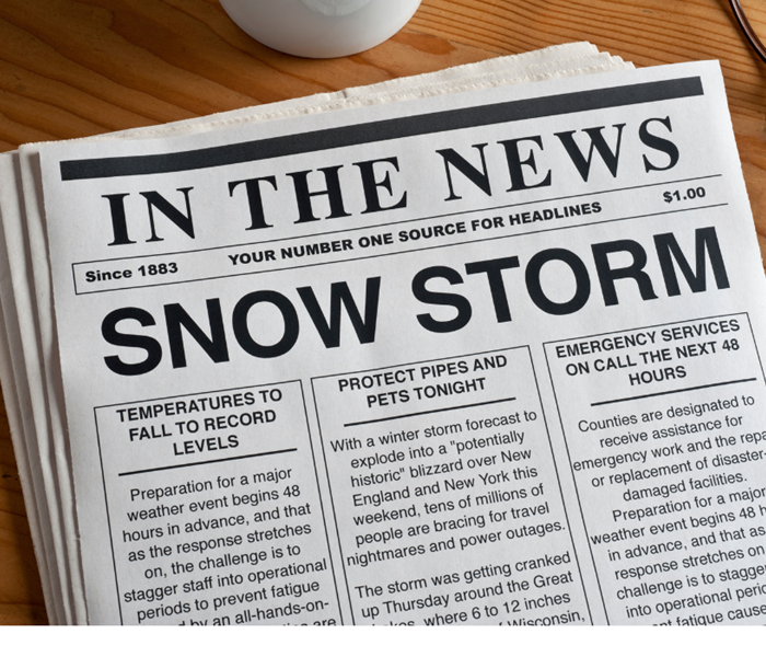 a newspaper reading SNOW STORM
