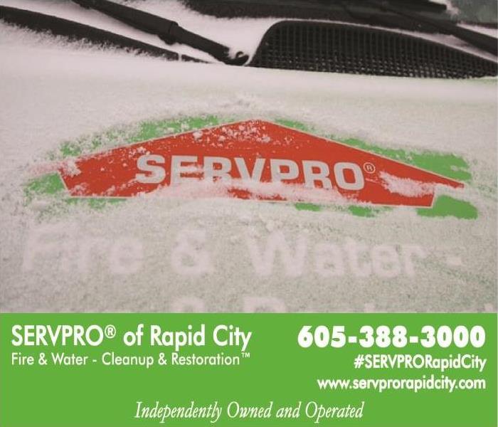 Servpro van with snow on hood removed where the logo is.